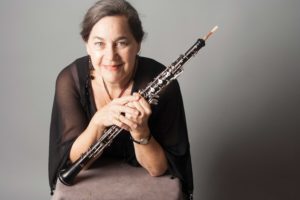 Woman poses with oboe.