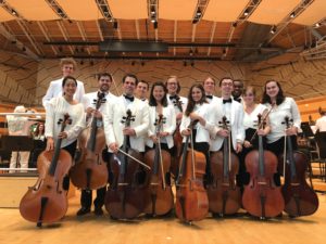 Cellists pose with their instruments and instructor.