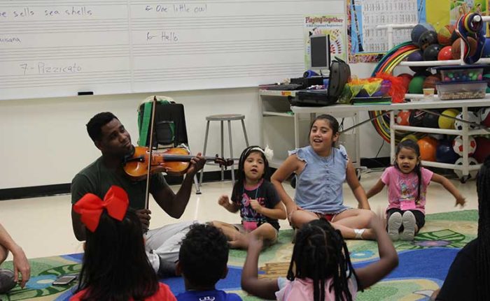 Children learn from Houston Symphony musicians during the Camp Adventure summer program.