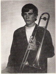 Man holding trombone.