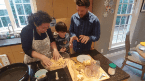 Family making potato latke in a kitchen.